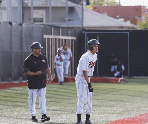 Coach PJ Garcia coaching third base